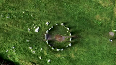 Top-down-aerial-shot-looking-down-on-the-Drombeg-Stone-Circle-rotating-around-in-a-circle-in-County-Cork,-Ireland