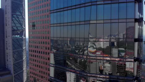 drone descending tall buildings in mexico city reflection landscape colors daylight