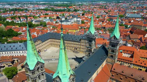 4k aerial drone video of the beautiful copper spires on the bell towers of the bamberg cathedral in the old town area of bamberg, germany