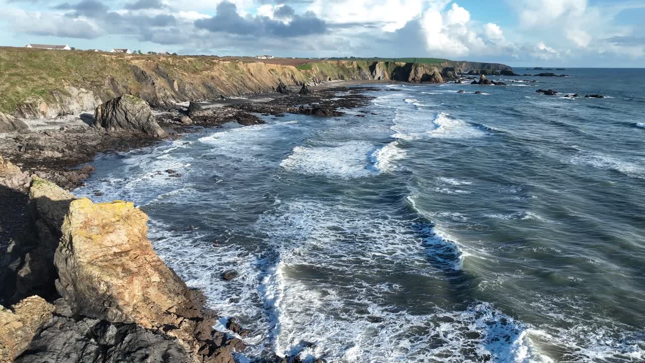 Ireland drone view of rough seas incoming waves at Benvoy Beach Copper Coast Waterford on an autumn day