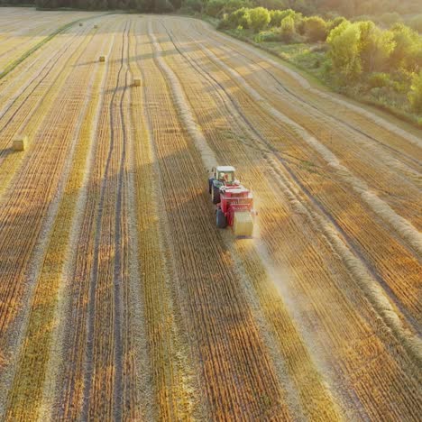 tractor collecting straw bales