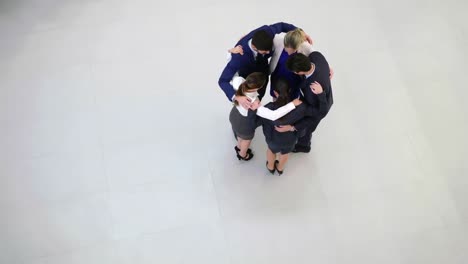 team of businesspeople forming huddle