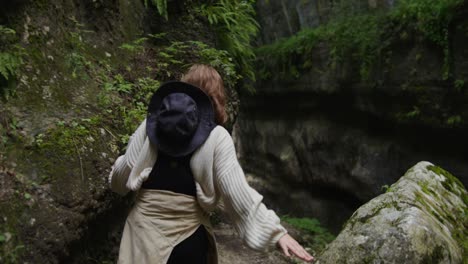 woman hiking through a mountain canyon