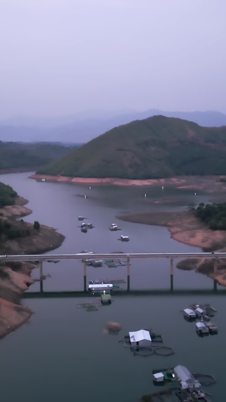 Scenic view of a lake with a bridge and mountains