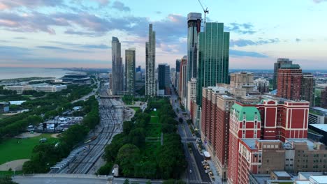 Aerial-view-of-Chicago's-skyline-overlooking-Millennium-Park-with-modern-skyscrapers,-Lake-Michigan,-and-bustling-streets