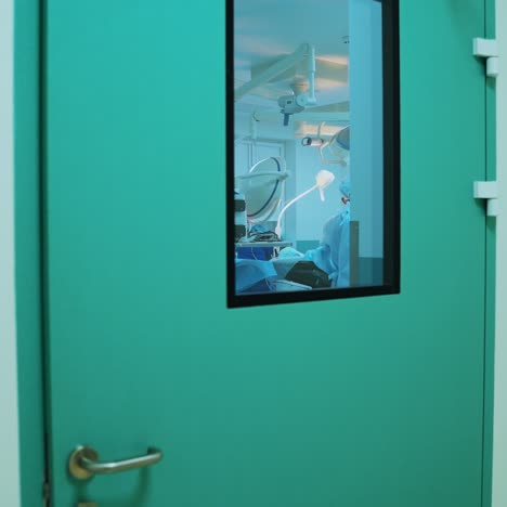 surgical process in the operating theatre. modern equipment in clinic. view from the window of the door in the surgery room.