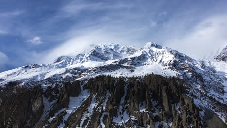 day timelapse of annapurna mountain range with clouds in a sunny day from manang, nepal