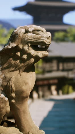 stone lion statue at a japanese temple