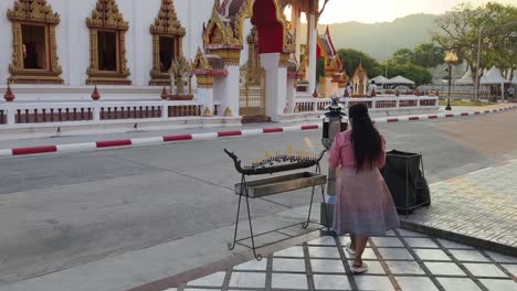 woman praying at a thai temple