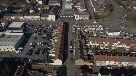 4k aerial view of a residencial area in taunton somerset, united kingdom, drone moving forward and showing the buildings roofs and street