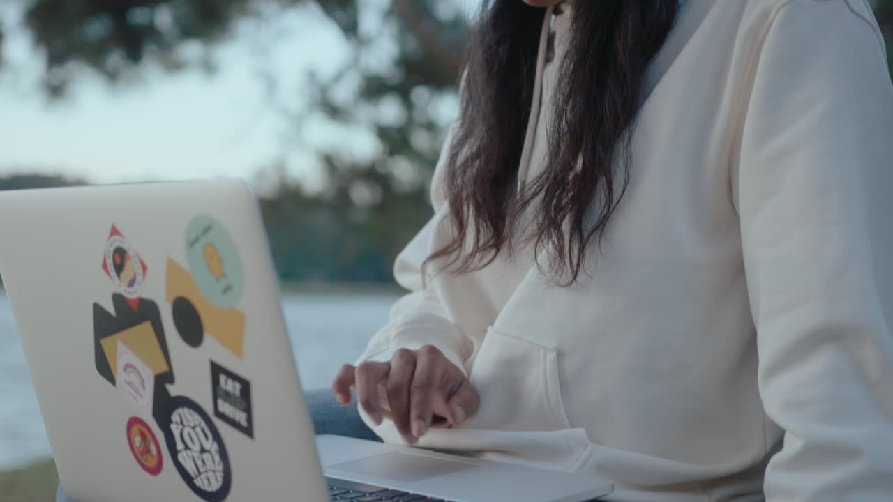 Asian Girl Using the Internet on Laptop in the Park