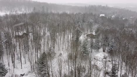 snowy sherbrooke canada forest with cabins aerial