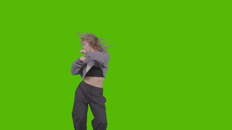 studio shot of young woman having fun dancing against green screen 29