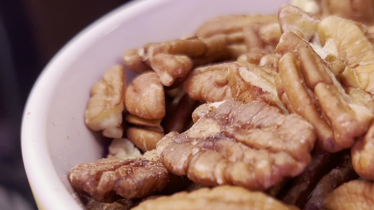 Close-up of walnut pieces in a bowl, highlighting their texture and natural beauty