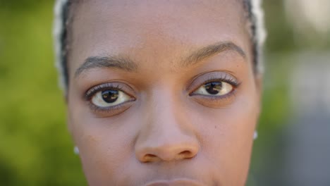 Portrait-of-happy-african-american-woman-looking-at-camera-in-garden-in-slow-motion