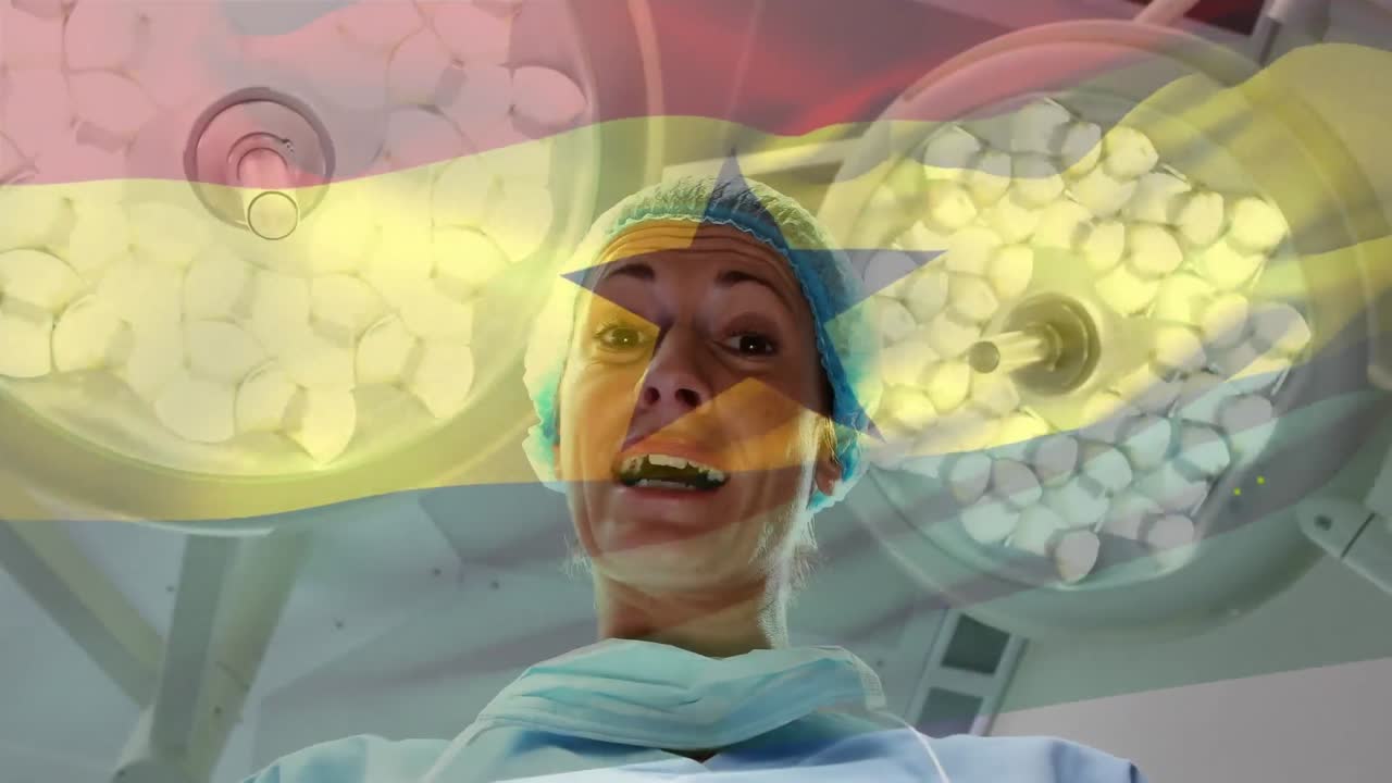 Animation of flag of ghana waving over surgeon in operating theatre