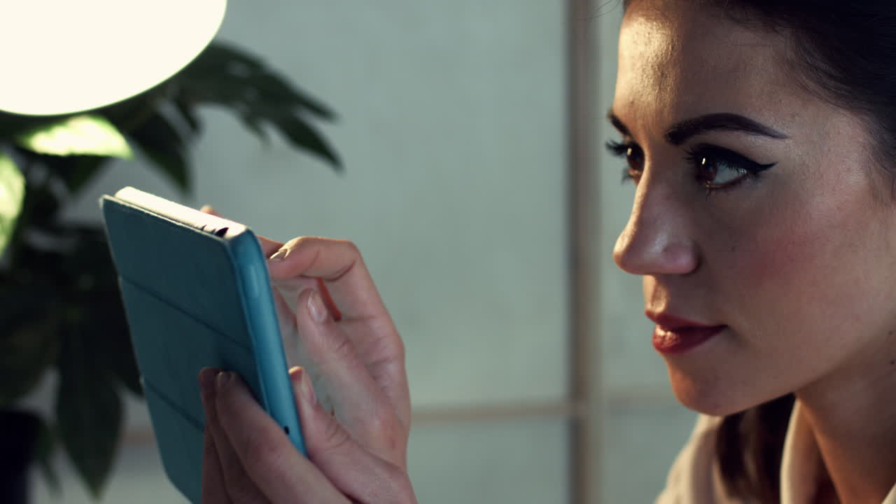 Attractive woman using digital tablet touchscreen computer at home
