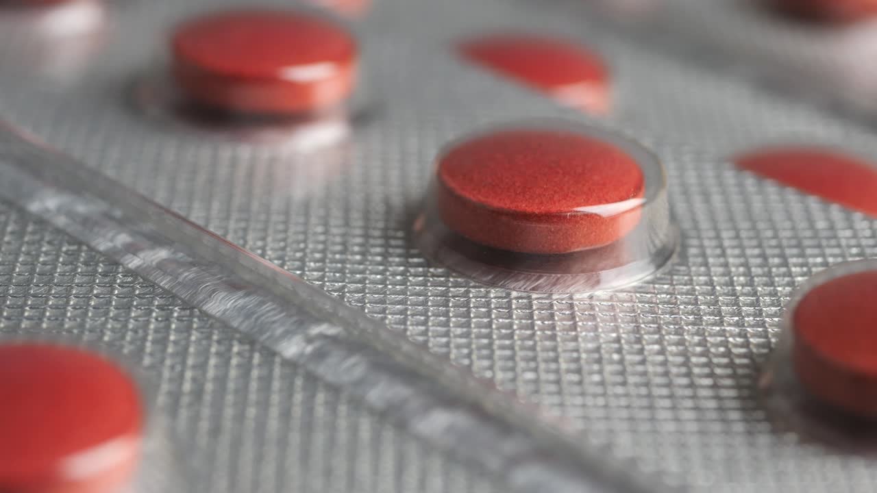 Macro Shot of Red Tablets in Pharmaceutical Blister Packaging