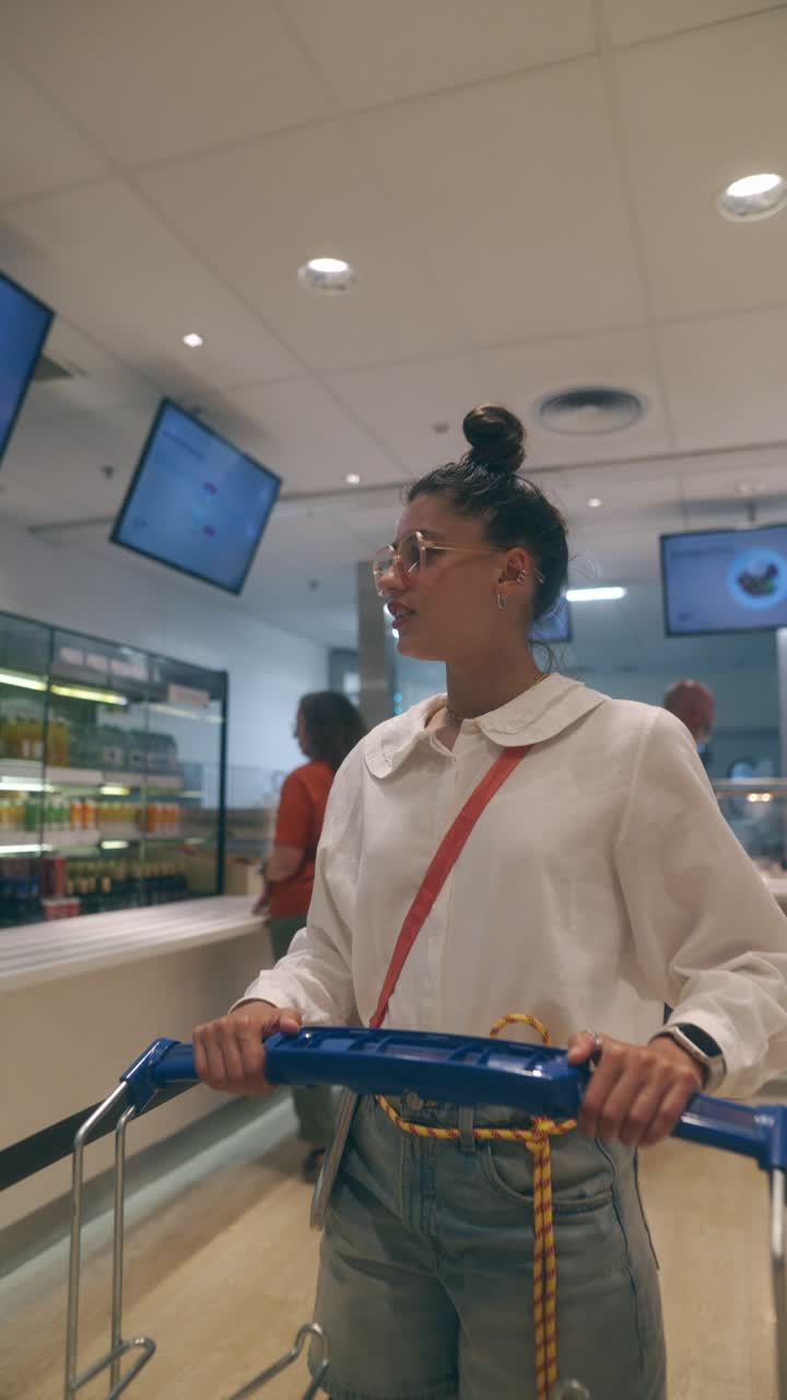 Woman pushing a cart in a modern cafeteria