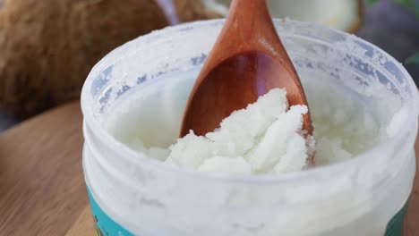 coconut sugar scrub in a jar with wooden spoon