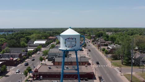 Close-up-push-in-aerial-shot-of-the-Swedish-Coffee-Pot-Water-Tower-in-downtown-Lindstrom,-Minnesota