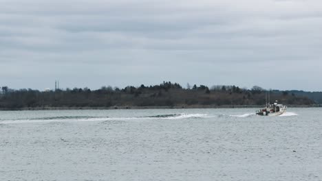 Boat-With-Passengers-Sailing-Across-The-Bay-In-Town-Of-Hull-In-Massachusetts---wide-shot