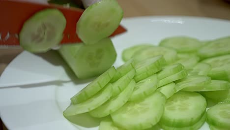 a peeled green cucumber that is sliced