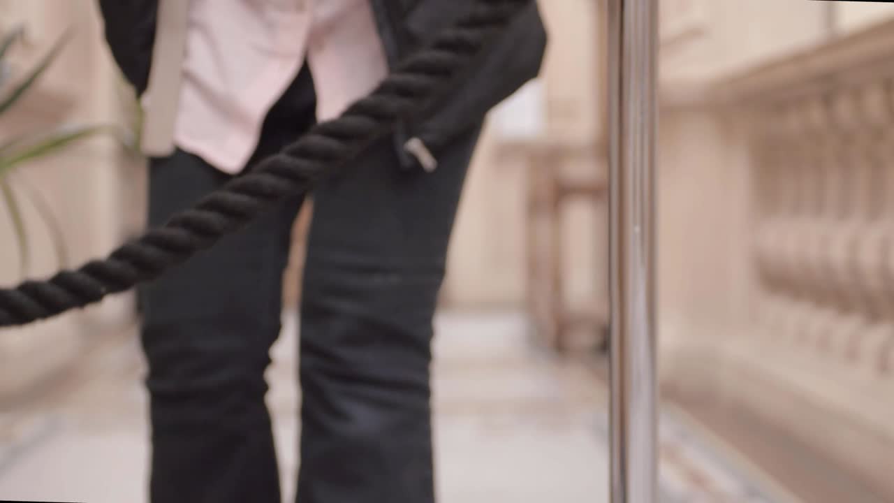 Person walking towards event rope stanchion in lobby