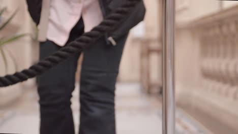 person walking towards event rope stanchion in lobby