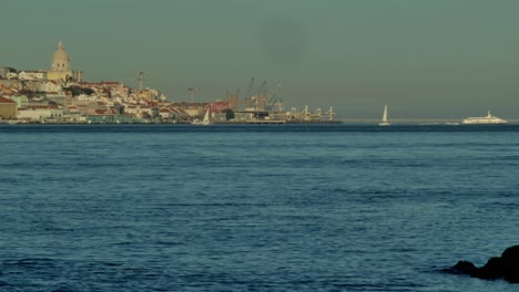 A-sailboat-in-river-tejo-and-Lisbon