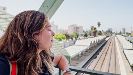young woman enjoying a scenic view of a train station
