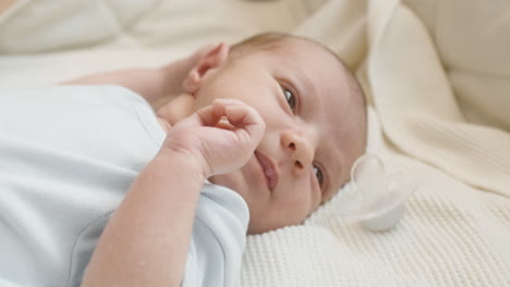 close up of a cute newborn baby lying on bed and crying 3