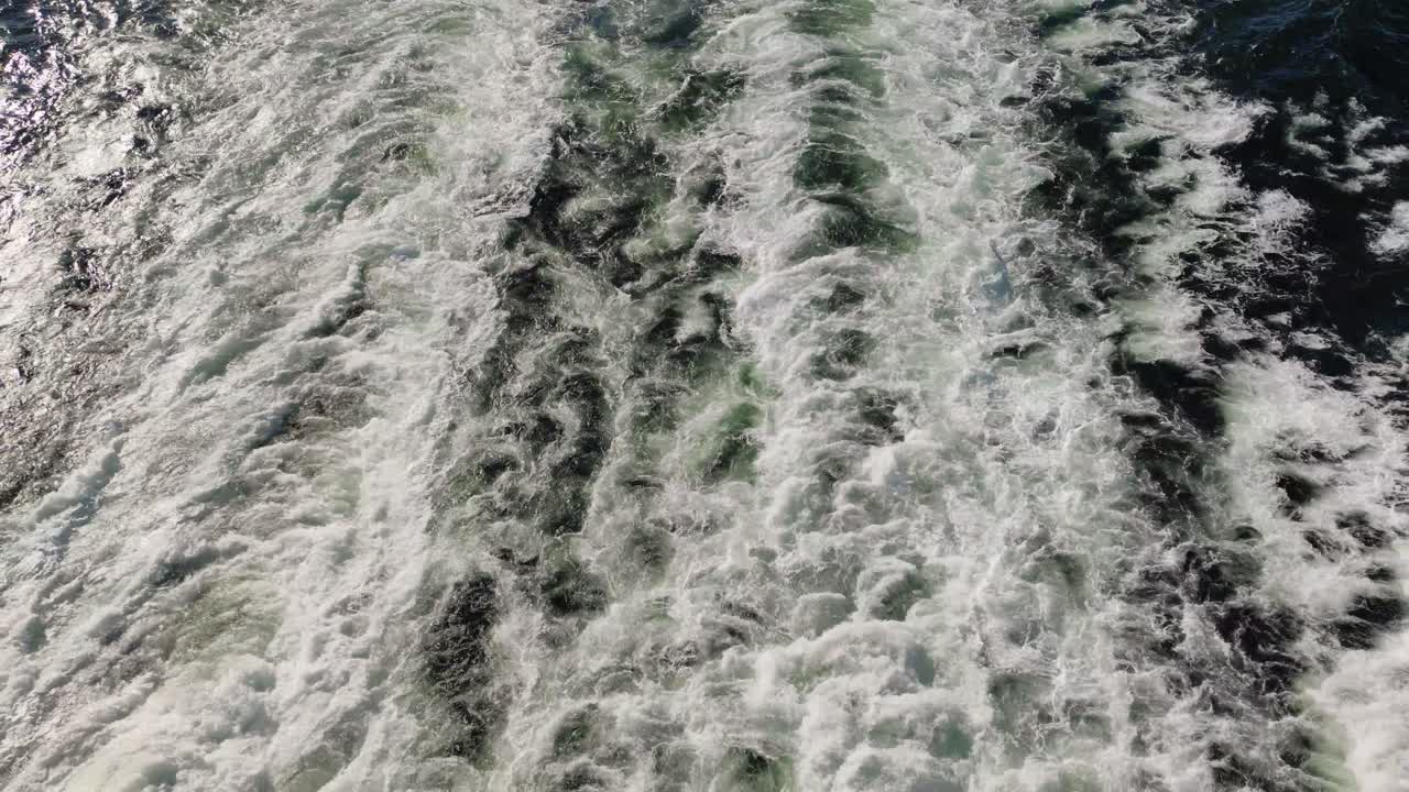 Top-down view of water flowing in the sea after the big boat - ferry