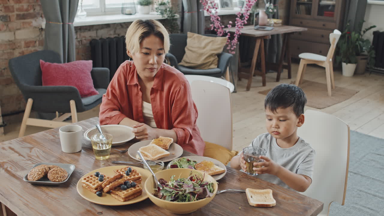 Asian Mother and Son Having Breakfast at Home