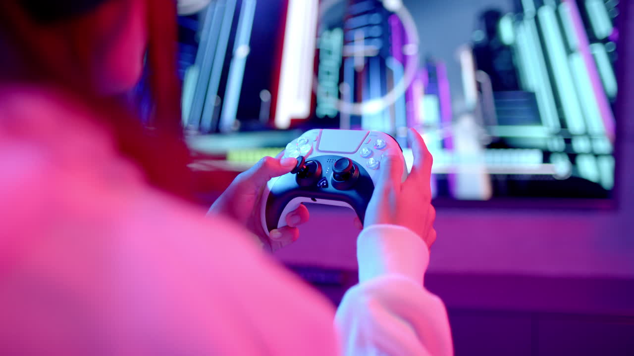 Playing video game, teenage girl holding game controller and focusing on screen