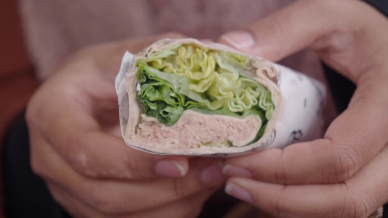 Person eating a wrap