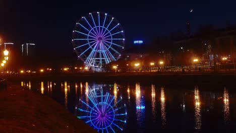 time lapse, ferris wheel on the embankment in the evening