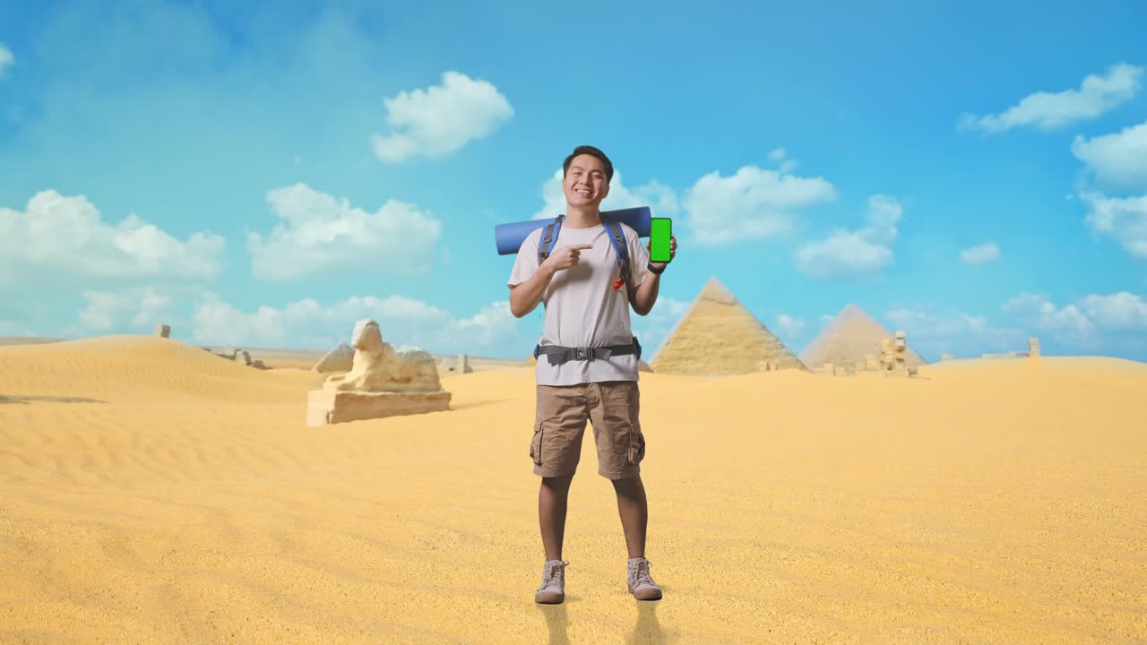 Smiling Tourist in Desert with Green Screen Phone