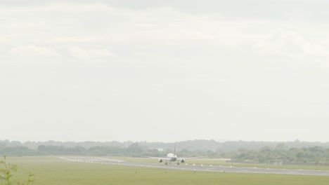 A-wide-shot-in-slow-motion-of-a-large-plane-taking-off-from-a-runway