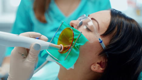 woman sitting at dental chair. young female patient visiting dentist office