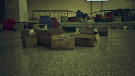 abandoned airport terminal features empty boxes and abandoned luggage remnants