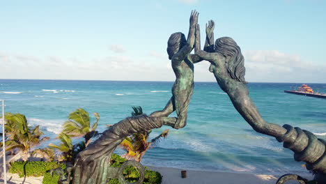 Aerial-view-of-the-Mayan-Portal-Monument-during-a-sunny-day-at-Playa-del-Carmen-in-the-Mayan-Riviera,-México