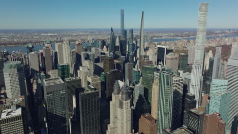 Aerial-footage-of-office-towers-and-high-rise-buildings-in-midtown.-Central-Park-and-Hudson-river-in-background.-Manhattan,-New-York-City,-USA