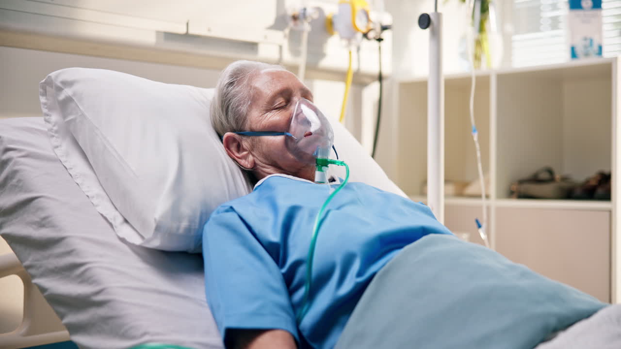 Elderly Patient Resting in Hospital Bed with Oxygen Mask