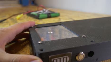 assembling 3d printed electronics case with screwdriver in workshop