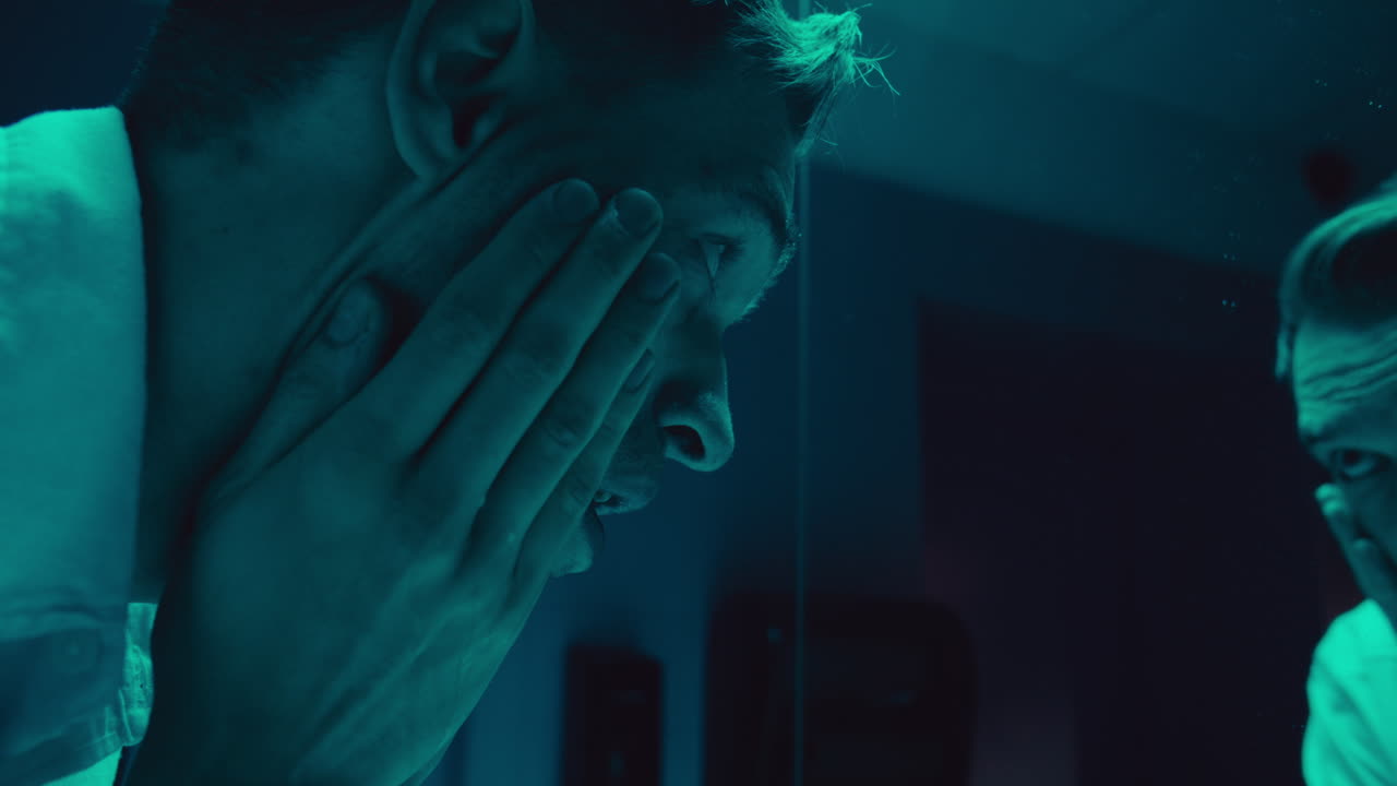 Depressed Man Washing Face in Bathroom