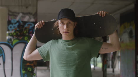 caucasian skateboarder in a ruined building.