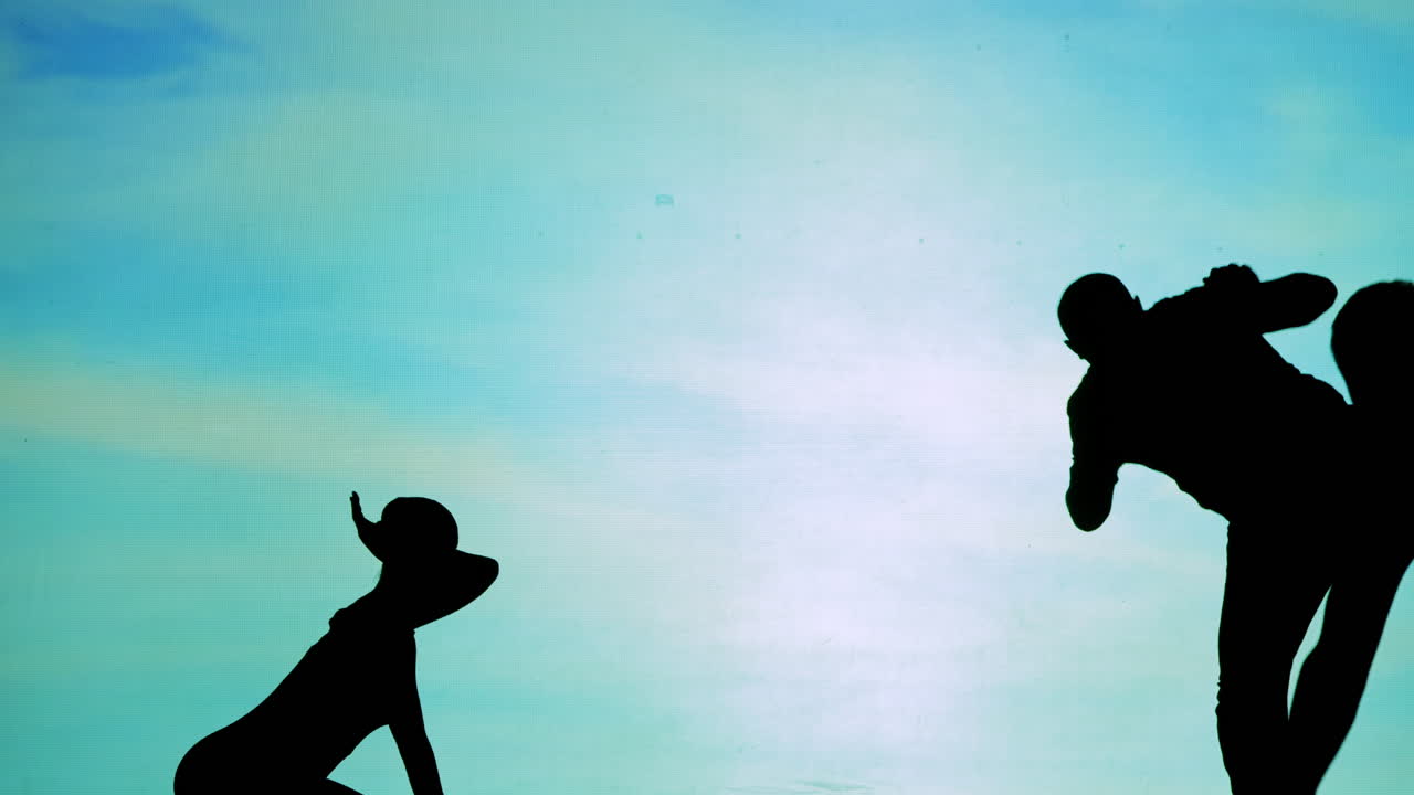 Silhouettes of people and dogs