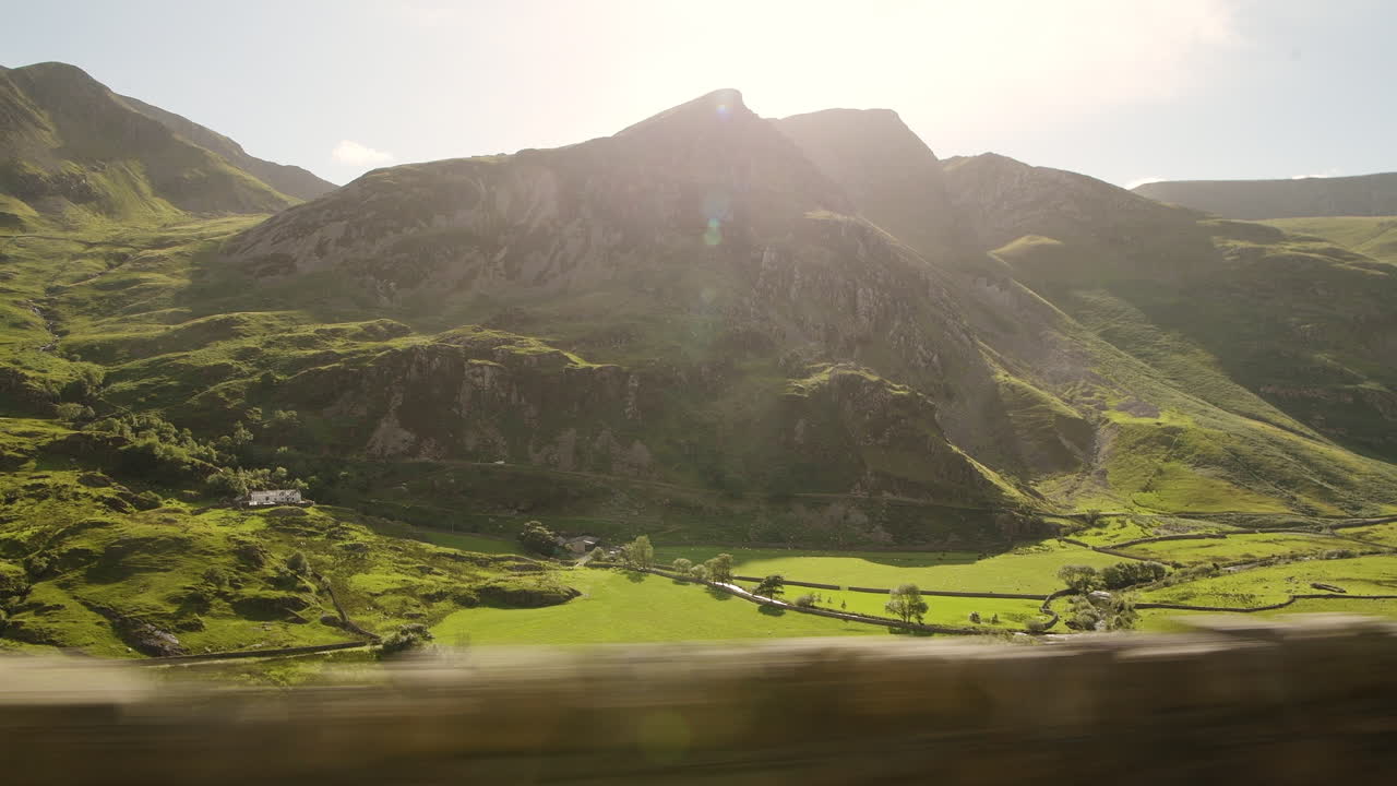 Scenic Drive Through The Lush Green Mountain Terrain During Sunset In Snowdonia National Park In Wales - Wide Shot