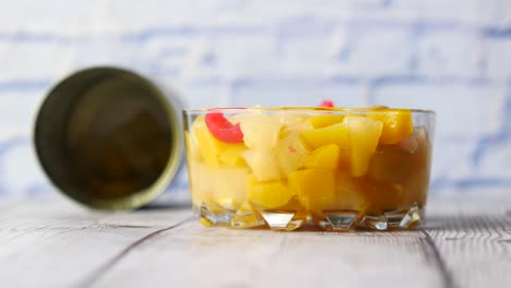 canned pineapple and fruit salad in a glass bowl